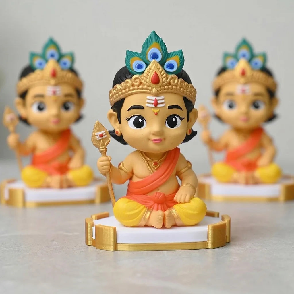 Three colorful figurines of a deity on stands with a plain background
