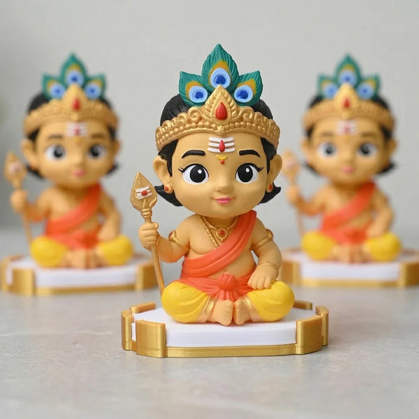 Three colorful figurines of a deity on stands with a plain background