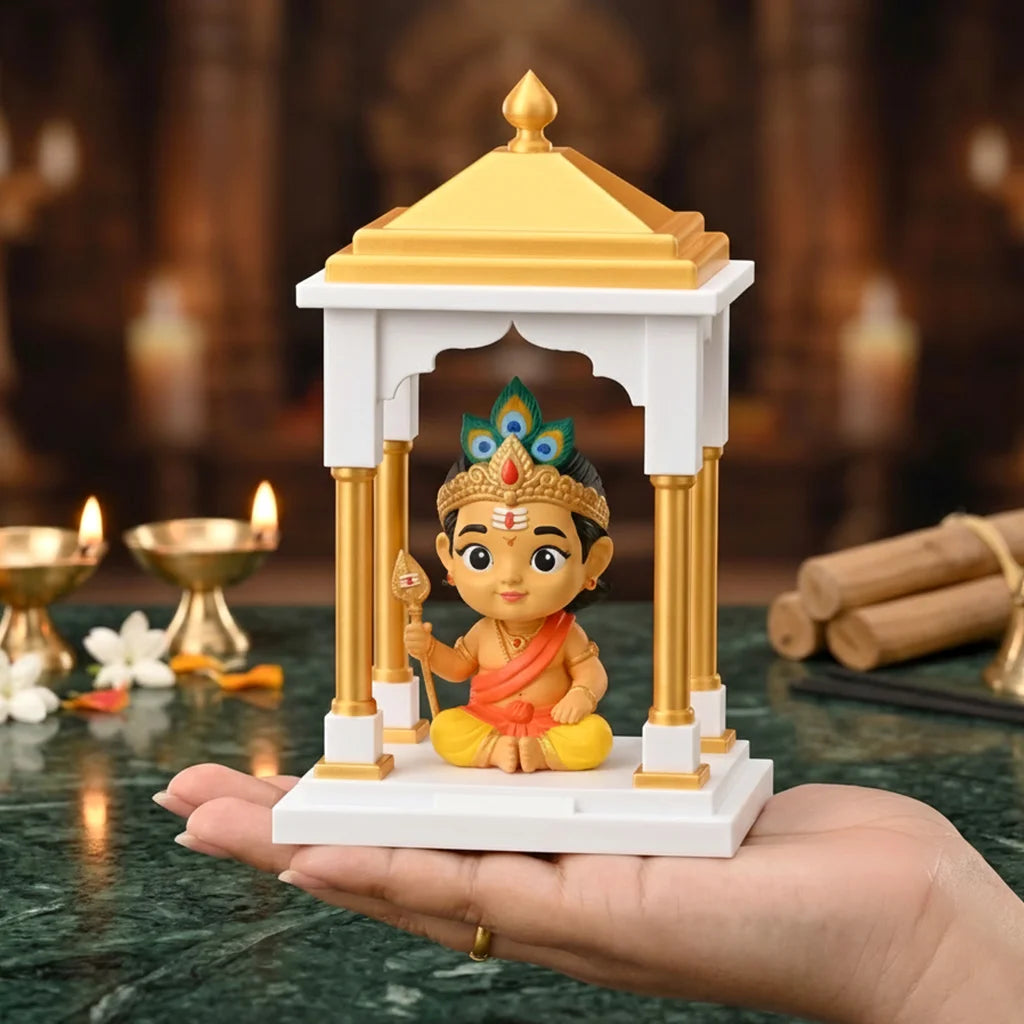 Bala Murugan Miniature figurine of a deity in a temple-like structure held in a hand with Diwali decorations in the background.