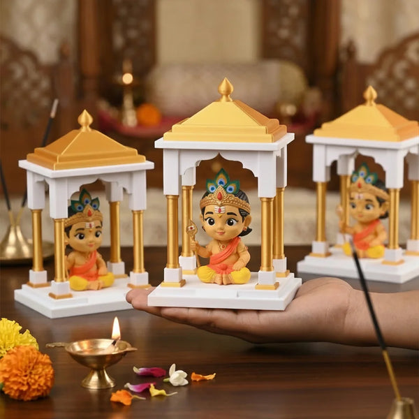 Small temple with figures on a hand, surrounded by decorative items on a wooden surface.