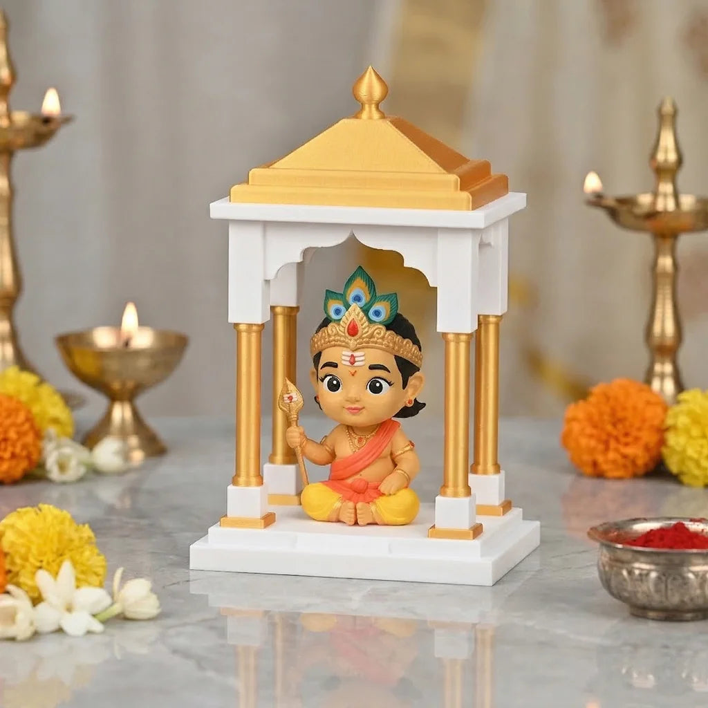 Small Bala Murugan statue with a golden and white architectural structure on a reflective surface.